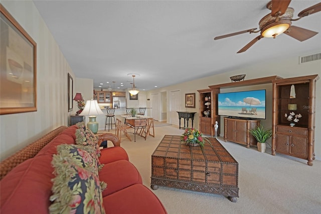 living room with light carpet and ceiling fan