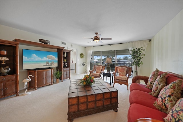 carpeted living room featuring ceiling fan