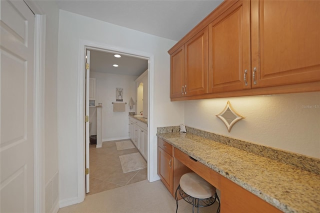 kitchen with light stone countertops and light tile patterned floors