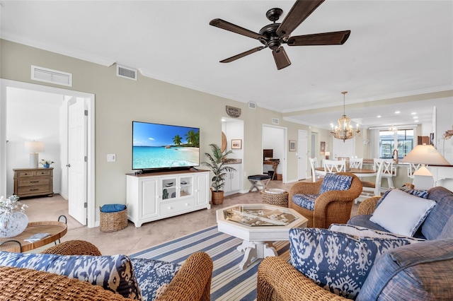 living room with ceiling fan with notable chandelier, light tile patterned floors, and ornamental molding