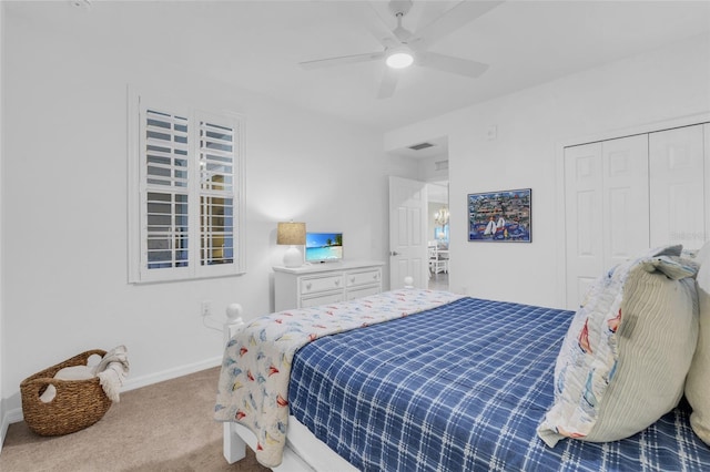 bedroom featuring ceiling fan, a closet, and carpet