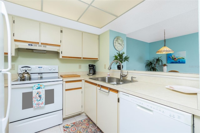 kitchen with sink, hanging light fixtures, light tile patterned floors, white appliances, and white cabinets