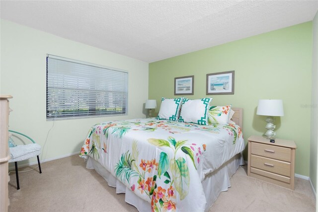 carpeted bedroom featuring a textured ceiling