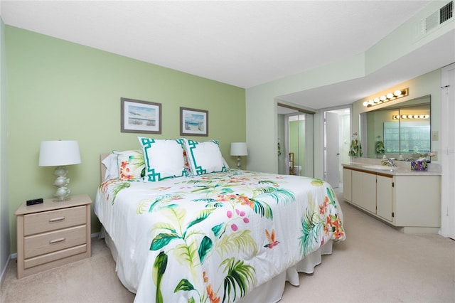 bedroom featuring light carpet and sink