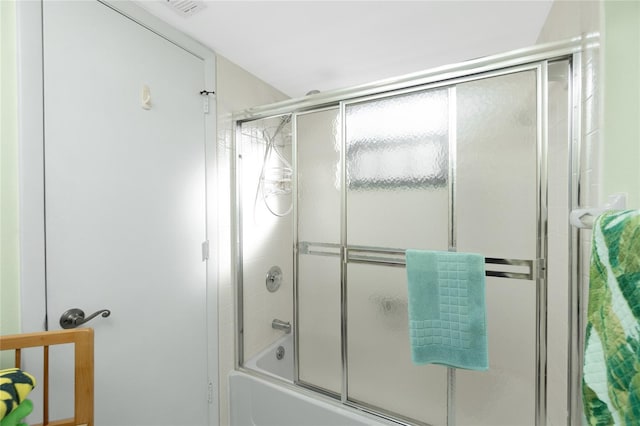 bathroom with shower / bath combination with glass door