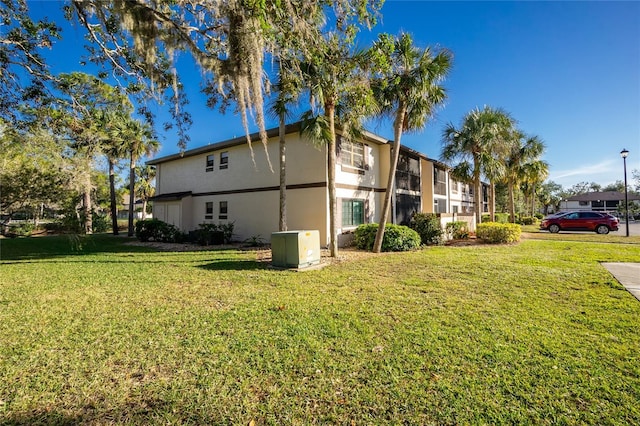 view of side of home with a yard