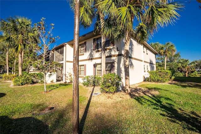 rear view of house featuring a lawn