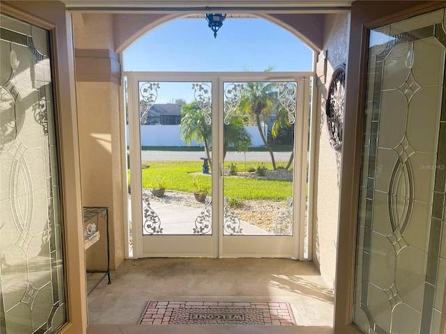 doorway with a water view and french doors