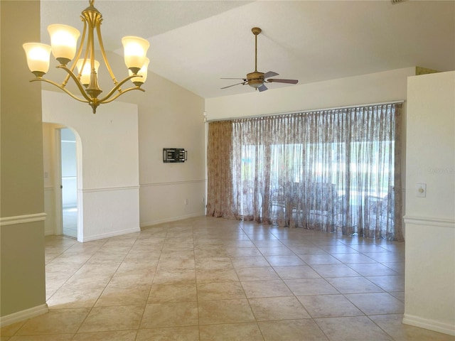 tiled spare room featuring ceiling fan with notable chandelier and vaulted ceiling