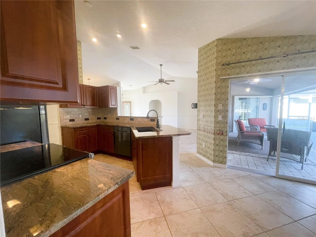 kitchen with kitchen peninsula, vaulted ceiling, ceiling fan, sink, and black appliances