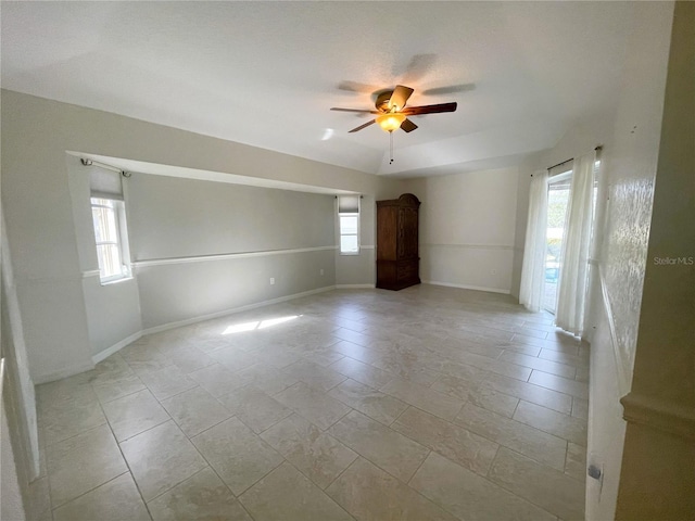 tiled spare room with ceiling fan