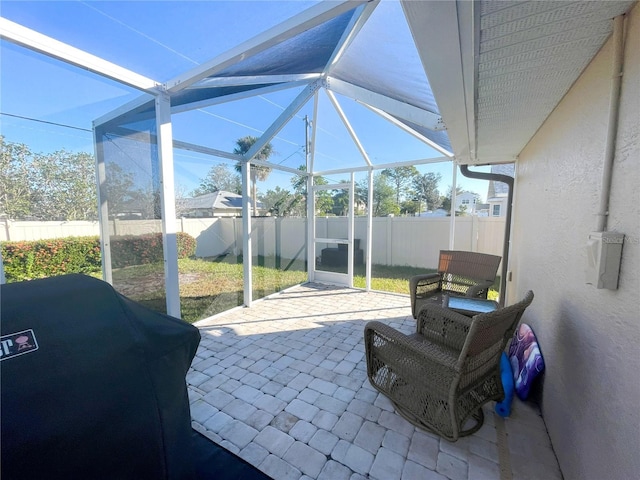 view of patio / terrace with a grill and a lanai