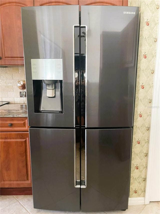 kitchen with tasteful backsplash, stainless steel fridge, and light tile patterned floors