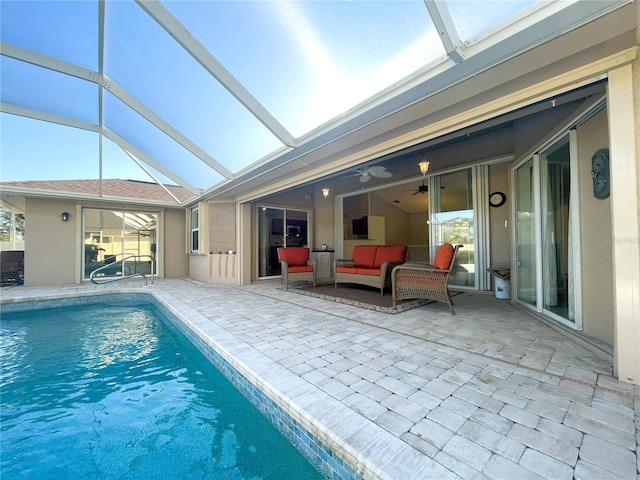 view of swimming pool featuring a lanai, a patio area, ceiling fan, and an outdoor hangout area