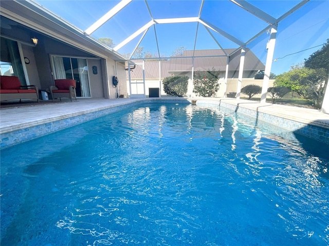 view of swimming pool with a lanai and a patio area