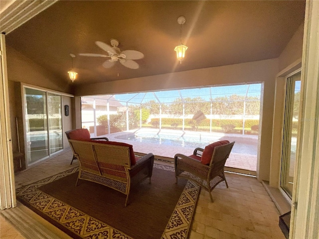 sunroom featuring ceiling fan and vaulted ceiling