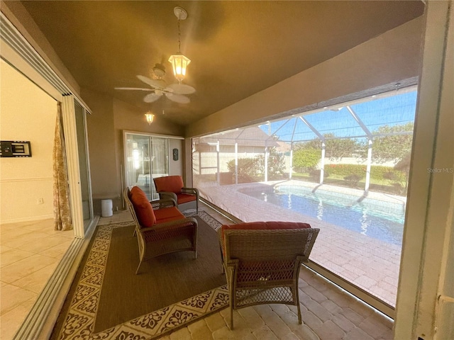 sitting room featuring ceiling fan and lofted ceiling