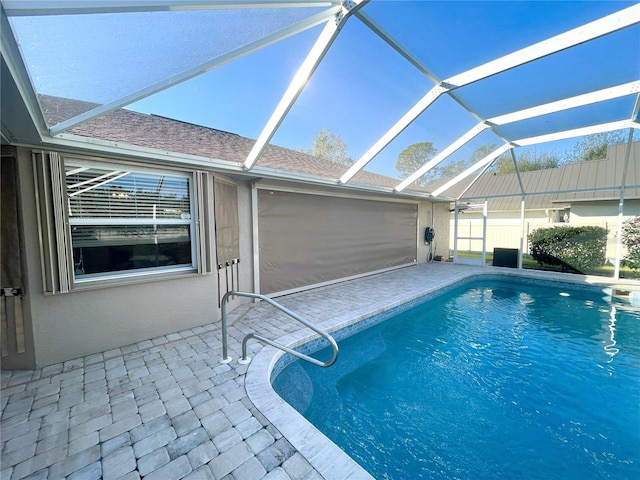 view of pool with a patio and a lanai