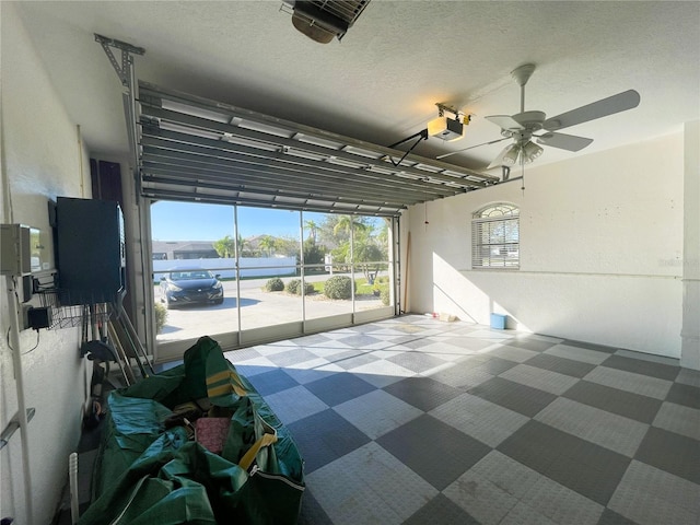 garage featuring ceiling fan and a garage door opener