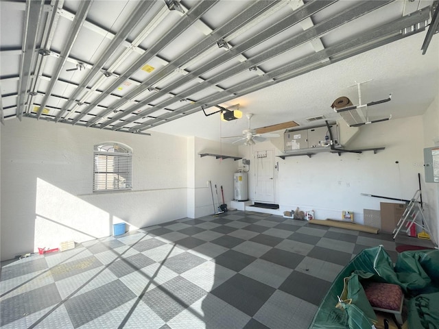 garage with electric water heater and a garage door opener