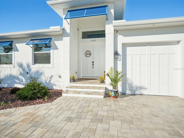 view of exterior entry featuring a garage