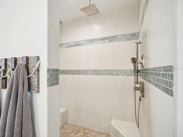 bathroom with a tile shower