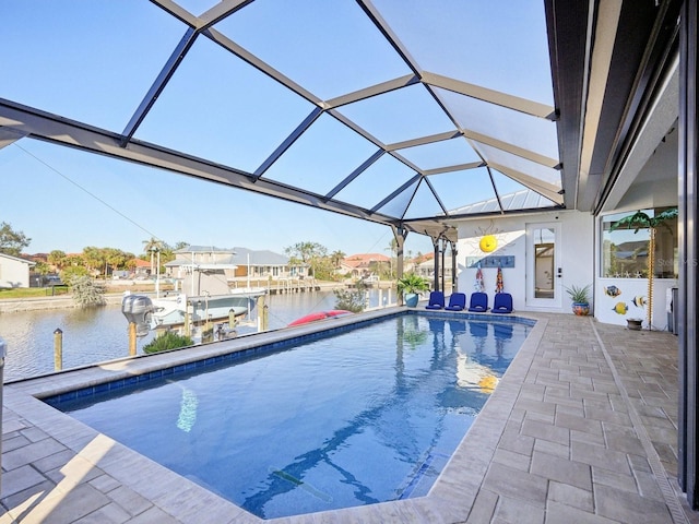 view of swimming pool featuring glass enclosure, a dock, a water view, and a patio