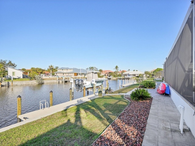 dock area featuring a lawn and a water view