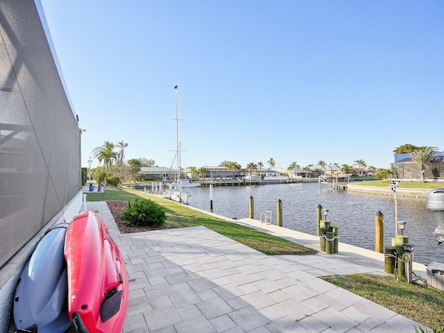 view of patio / terrace featuring a water view and a dock