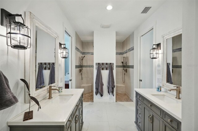 bathroom featuring walk in shower, visible vents, marble finish floor, and a sink