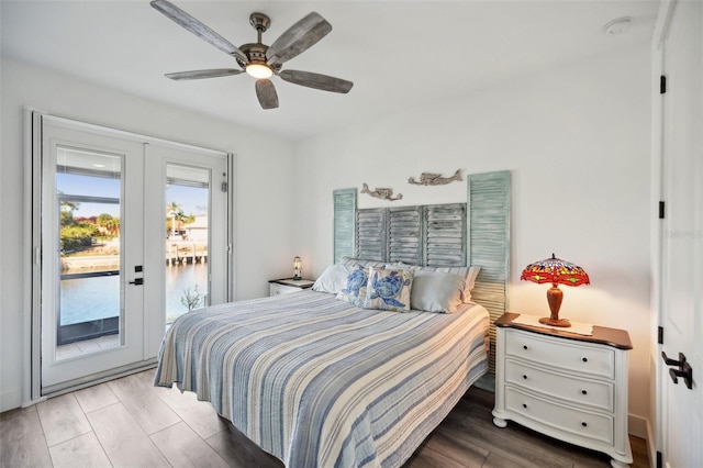 bedroom with access to outside, wood finished floors, french doors, and ceiling fan