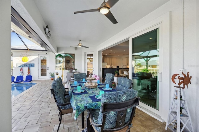 view of patio with an outdoor pool and ceiling fan