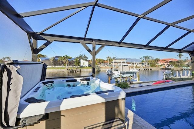 view of swimming pool featuring a boat dock, a hot tub, a water view, boat lift, and a lanai