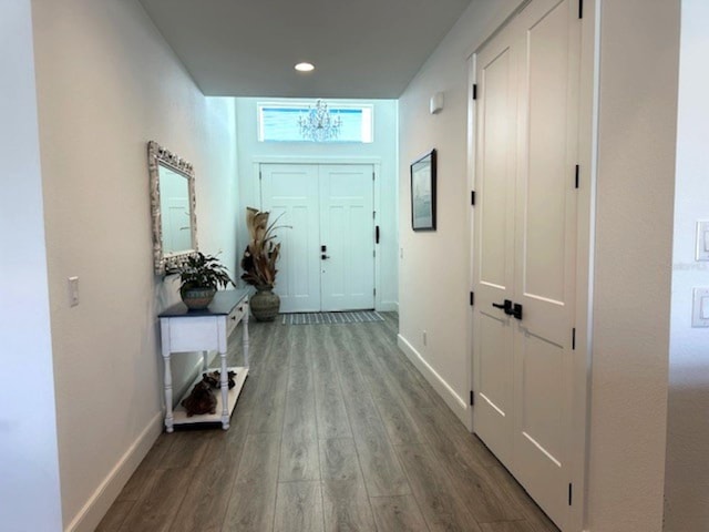 interior space with recessed lighting, baseboards, and wood finished floors