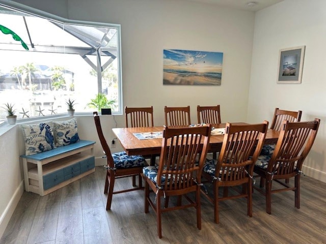 dining space with wood finished floors and baseboards