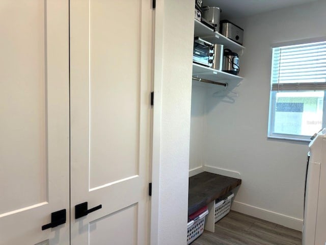 mudroom featuring baseboards and wood finished floors