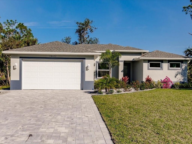 view of front of home with a front yard and a garage