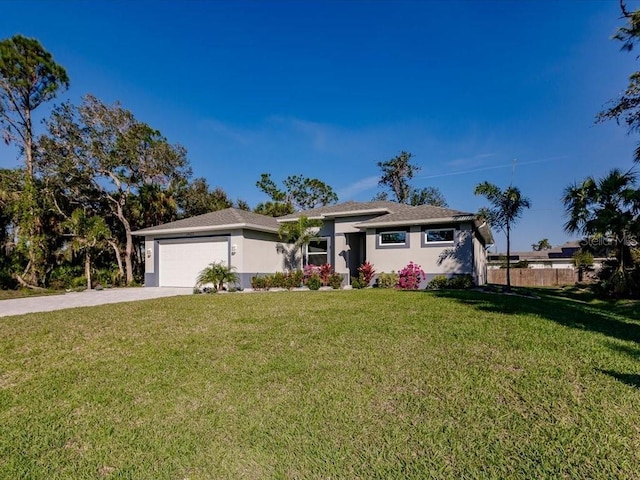 ranch-style home featuring a front lawn and a garage