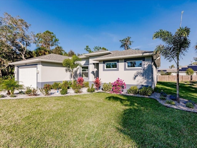 single story home with a garage and a front lawn