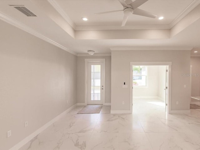 entryway featuring a raised ceiling, ceiling fan, and ornamental molding