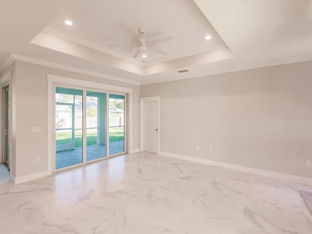 spare room featuring ceiling fan, crown molding, and a tray ceiling