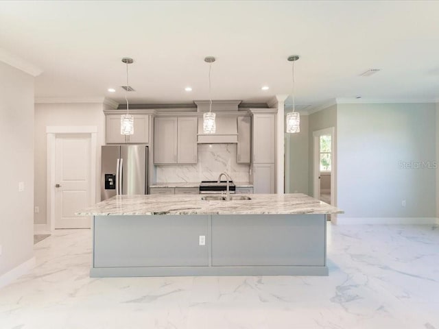 kitchen with gray cabinetry, stainless steel fridge with ice dispenser, a spacious island, and ornamental molding