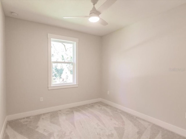 spare room with light carpet and ceiling fan