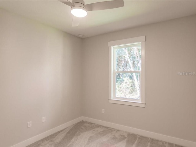 carpeted empty room with ceiling fan