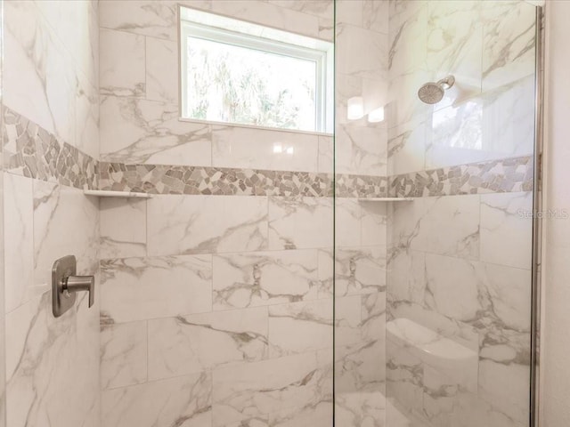 bathroom with tiled shower