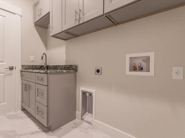 clothes washing area featuring washer hookup, electric dryer hookup, cabinets, and sink