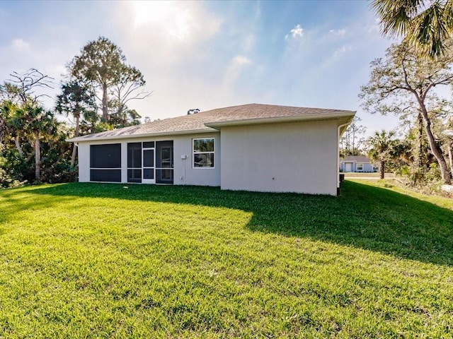 rear view of property with a yard