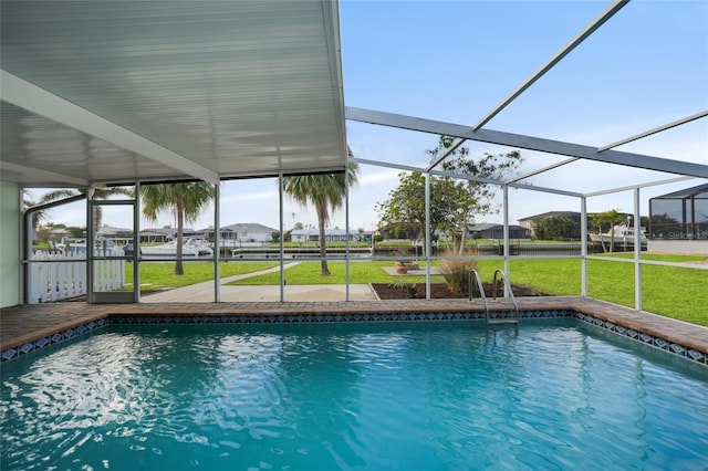 view of swimming pool with a lanai and a yard