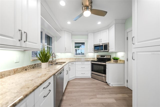 kitchen featuring white cabinetry, sink, and appliances with stainless steel finishes