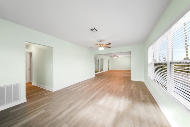 unfurnished living room with light hardwood / wood-style flooring and ceiling fan